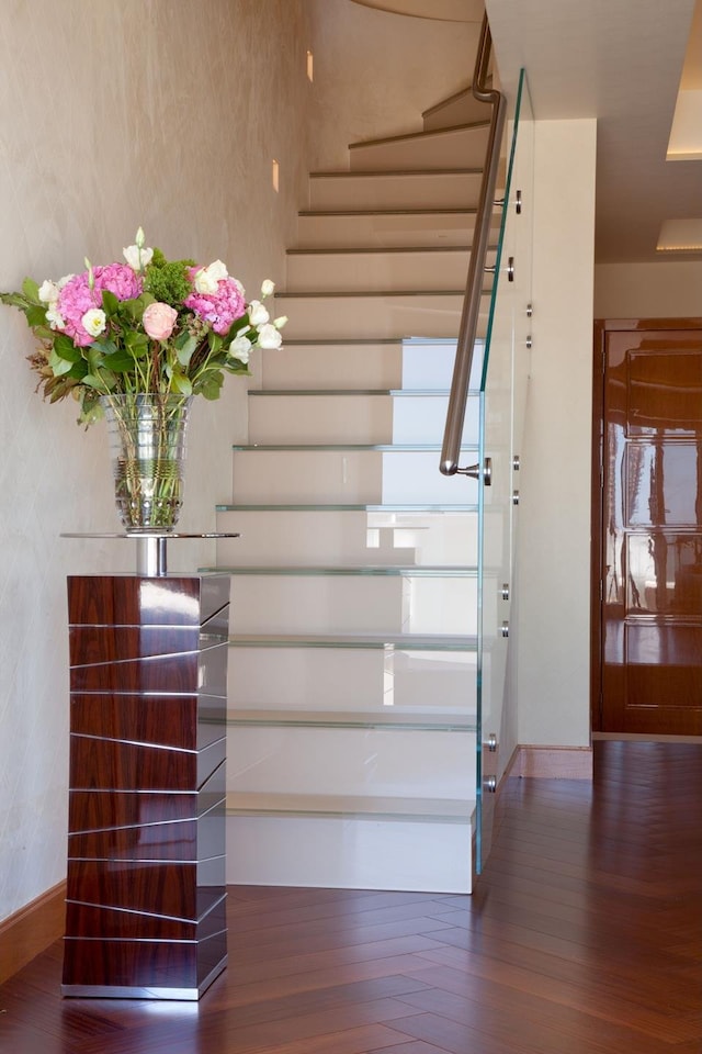 stairway featuring baseboards and wood finished floors