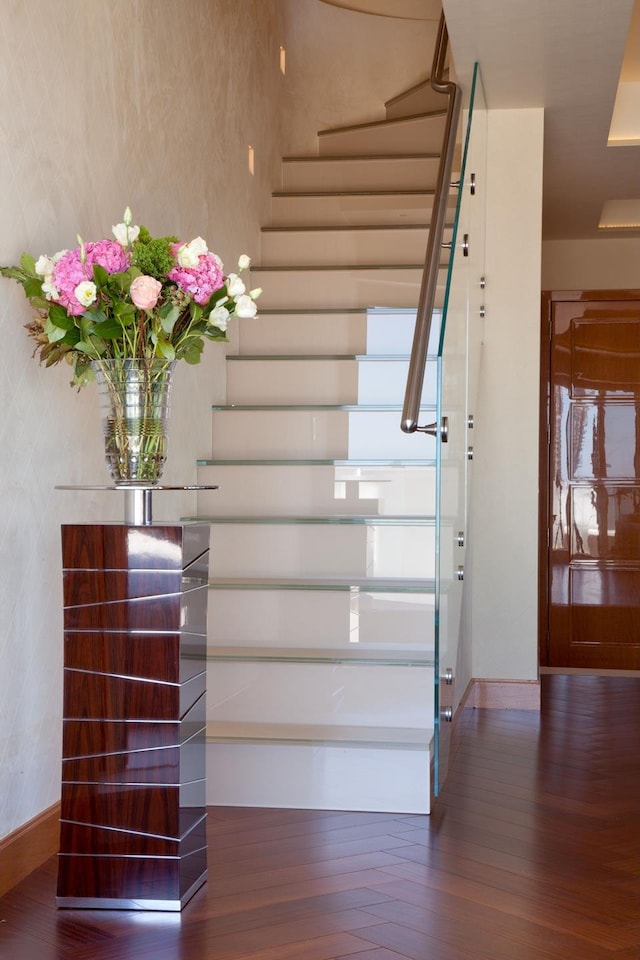 stairs with baseboards and wood finished floors