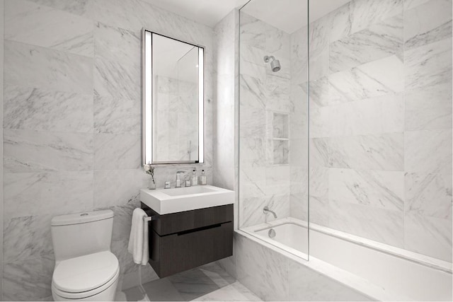 full bathroom featuring vanity, tiled shower / bath combo, tile walls, and toilet