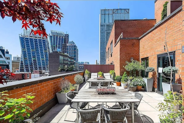 view of patio with a view of city and outdoor dining space