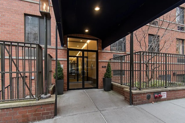 view of exterior entry with brick siding