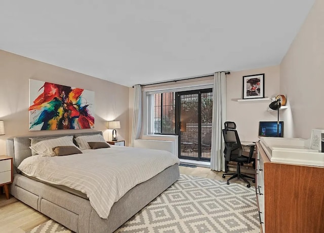 bedroom with light hardwood / wood-style floors and access to outside