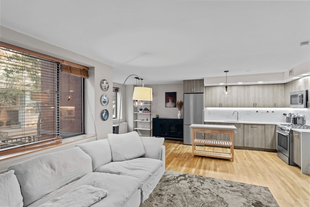 living area featuring light wood-style flooring and visible vents