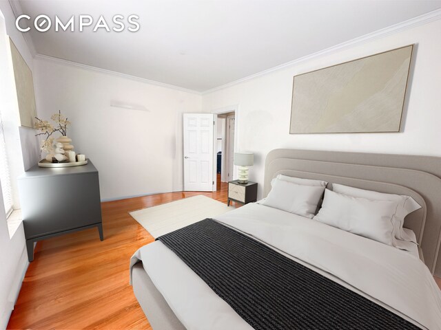 bedroom with crown molding and hardwood / wood-style flooring