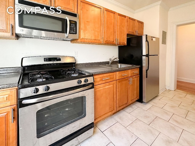 kitchen featuring stainless steel appliances, crown molding, sink, and light tile patterned floors