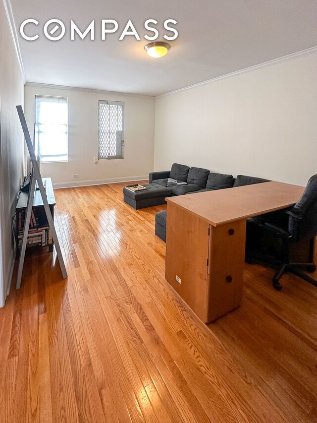 living room featuring ornamental molding and hardwood / wood-style floors