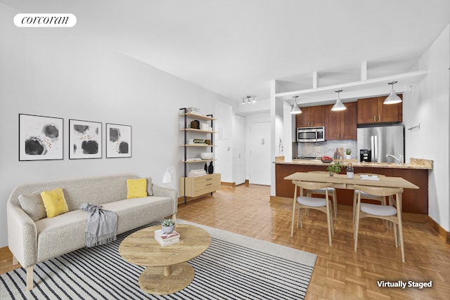 living area featuring visible vents and baseboards