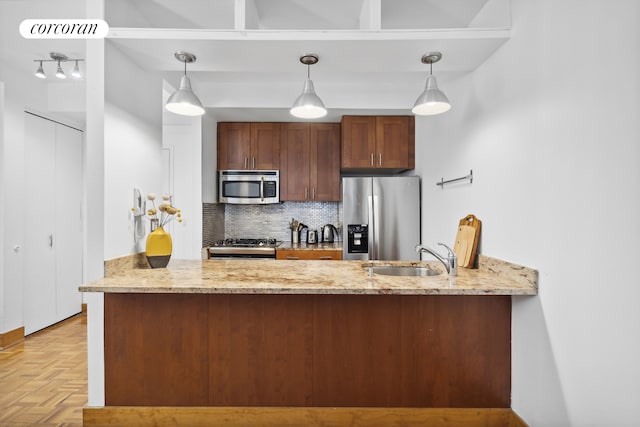 kitchen with tasteful backsplash, visible vents, appliances with stainless steel finishes, a peninsula, and a sink