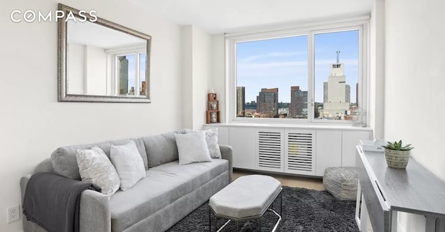 living room with a view of city and wood finished floors