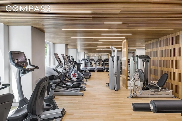 gym featuring wood ceiling and wood finished floors