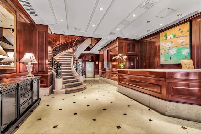 188 E 78th St Unit 4D, New York City, NY 10075 - reception featuring wood walls, stairway, and recessed lighting