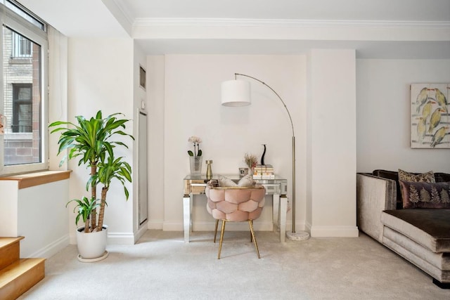 sitting room featuring ornamental molding and light carpet