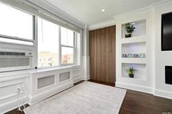 unfurnished living room with cooling unit, built in features, crown molding, and hardwood / wood-style floors