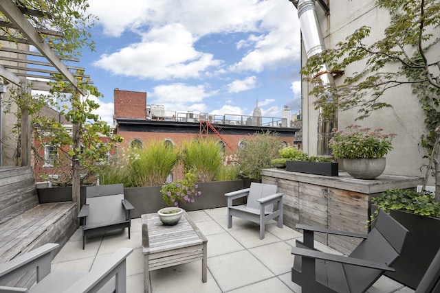 view of patio with an outdoor living space, exterior bar, and a pergola