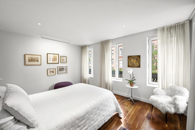 bedroom with dark hardwood / wood-style floors