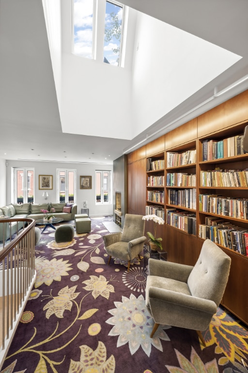 sitting room with built in features, plenty of natural light, and carpet