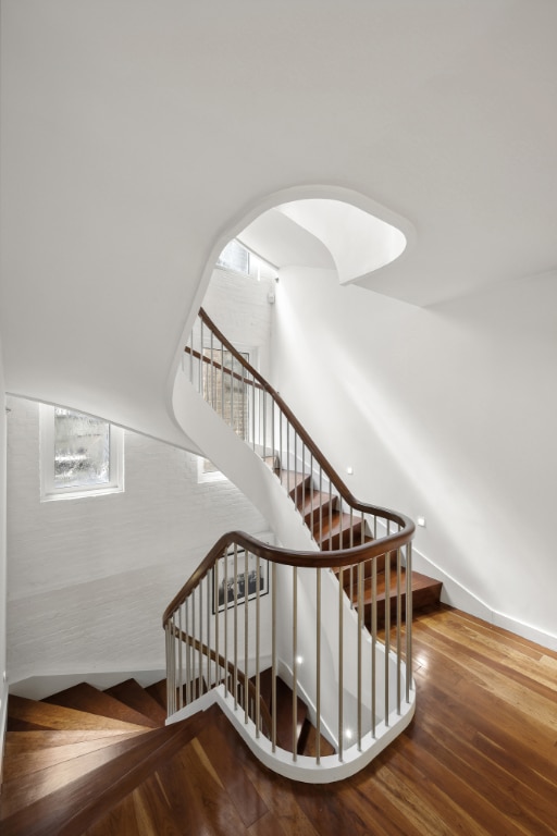 stairs featuring wood-type flooring