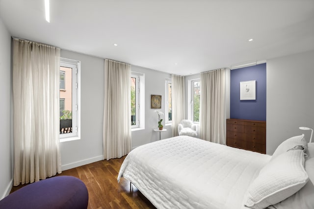 bedroom with dark hardwood / wood-style floors