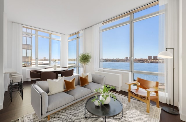 sunroom featuring a water view and a wealth of natural light