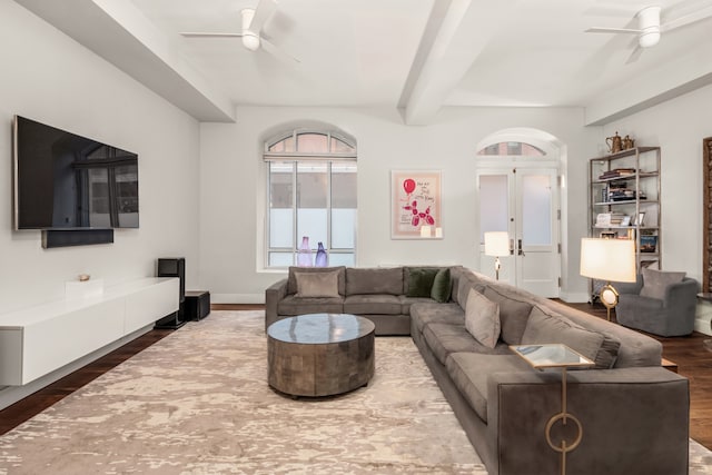 living room featuring beam ceiling, ceiling fan, french doors, and wood finished floors