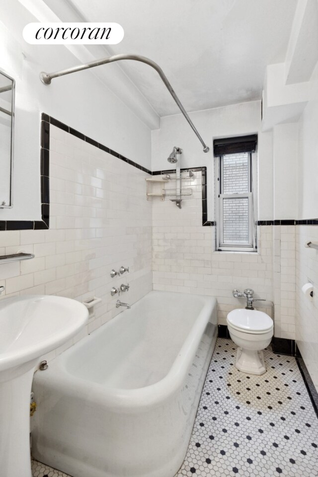 227 E 57th St Unit 16G, New York City, NY 10022 - bathroom with tile walls, shower / tub combination, toilet, and tile patterned flooring