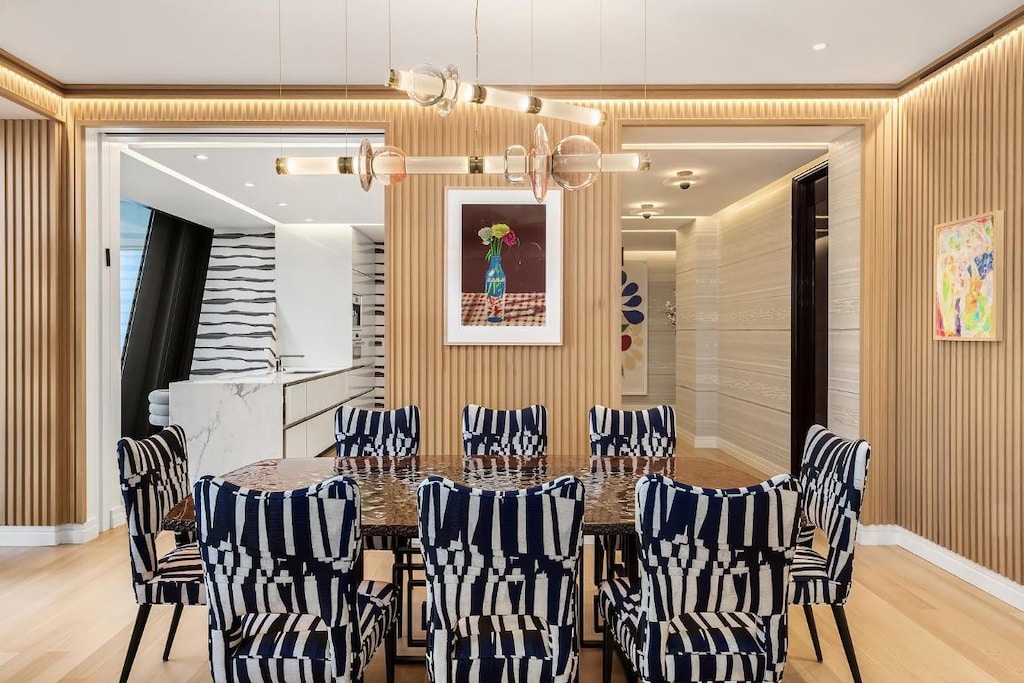 dining area featuring hardwood / wood-style flooring and a notable chandelier