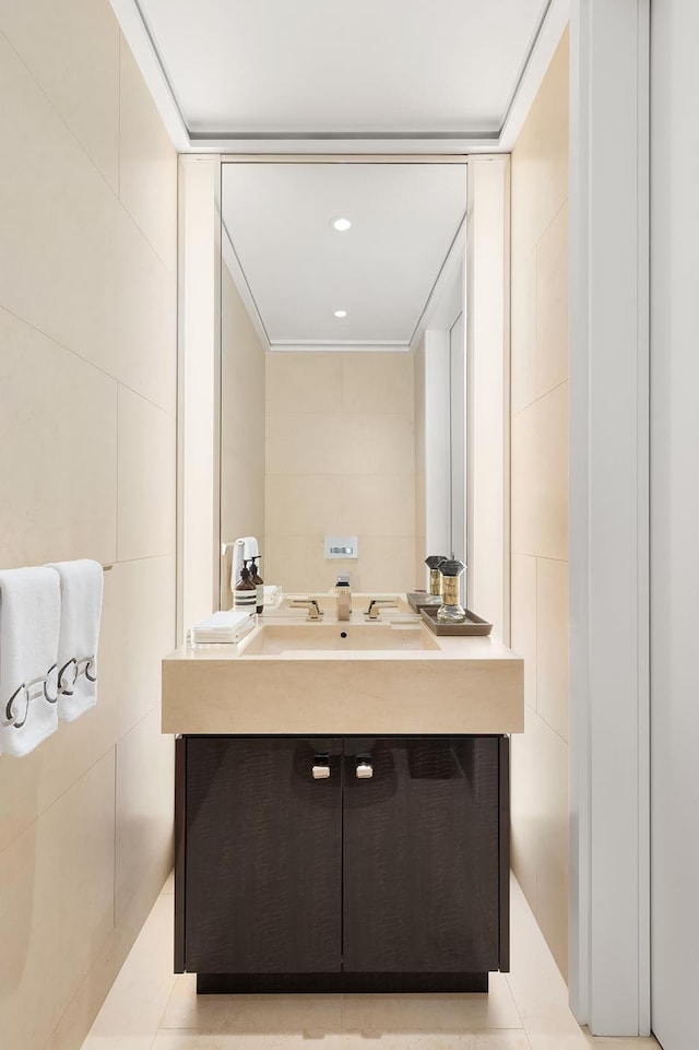 bathroom with recessed lighting, vanity, tile walls, and tile patterned floors