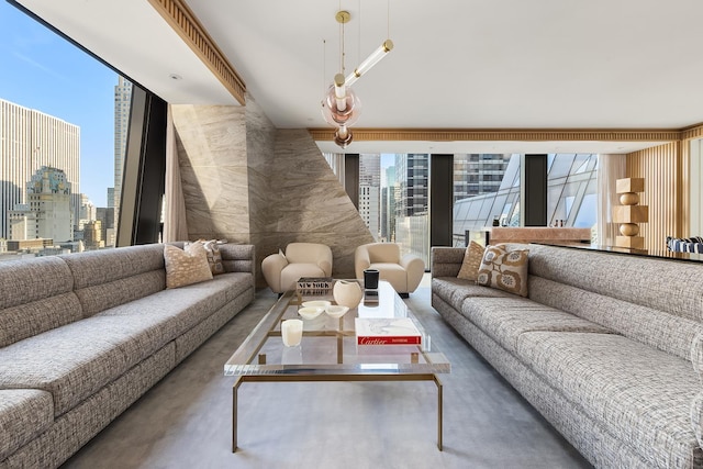 living room featuring concrete floors, a wealth of natural light, and a city view