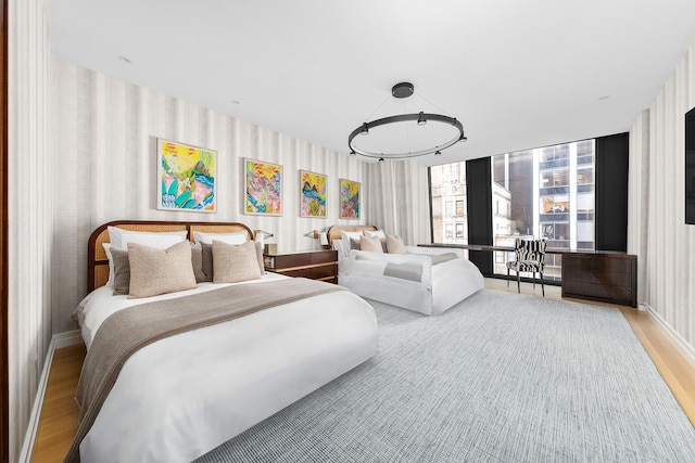 53 W 53rd St Unit 24A, New York City, NY 10019 - bedroom with wallpapered walls and wood finished floors