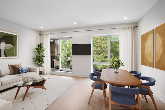 living room featuring baseboards, light wood-style flooring, and recessed lighting