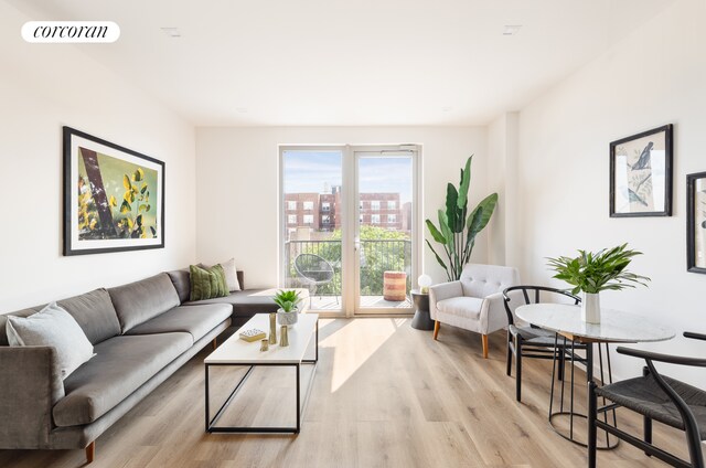 living room featuring a city view, visible vents, and light wood-type flooring