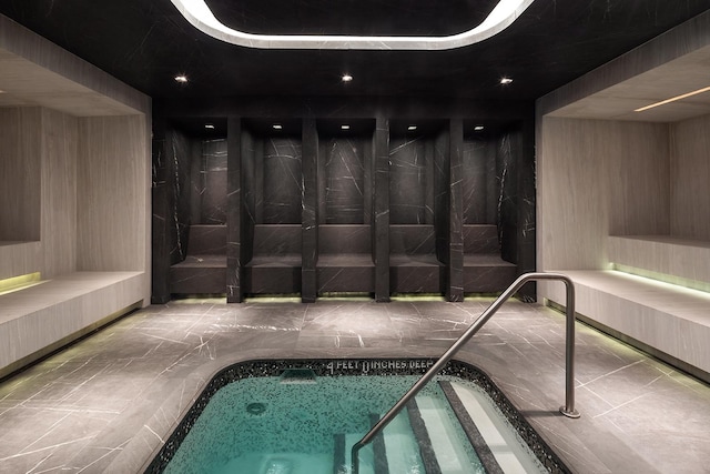 view of pool with an indoor hot tub