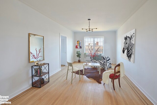 35-24 78th St Unit A67, New York City, NY 11372 - dining space with light wood-type flooring, a chandelier, baseboards, and ornamental molding