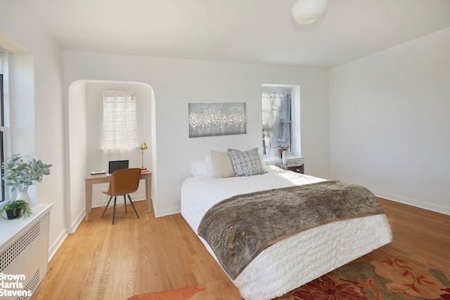 35-24 78th St Unit A67, New York City, NY 11372 - bedroom featuring light wood-style floors, radiator, baseboards, and an office area