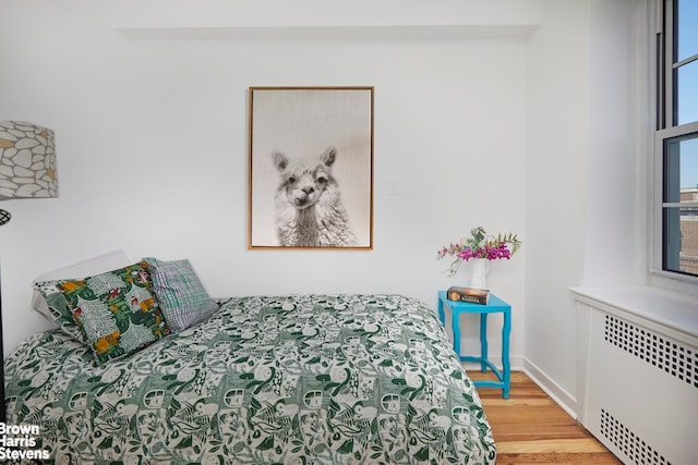 35-24 78th St Unit A67, New York City, NY 11372 - bedroom featuring radiator and light wood-style floors