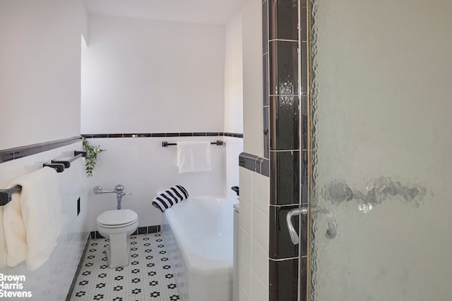 35-24 78th St Unit A67, New York City, NY 11372 - full bathroom with a stall shower, toilet, tile walls, wainscoting, and a garden tub