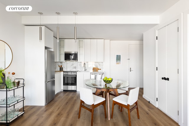 dining space featuring wood finished floors and visible vents