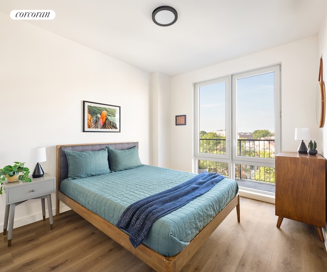 bedroom featuring visible vents and wood finished floors