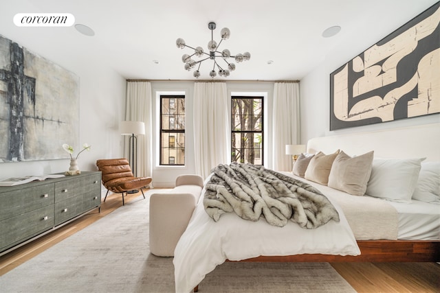 bedroom with visible vents and wood finished floors