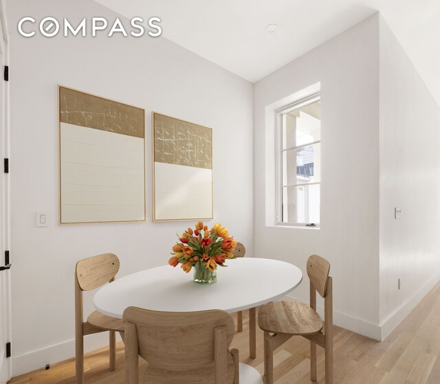 dining space featuring light wood-type flooring