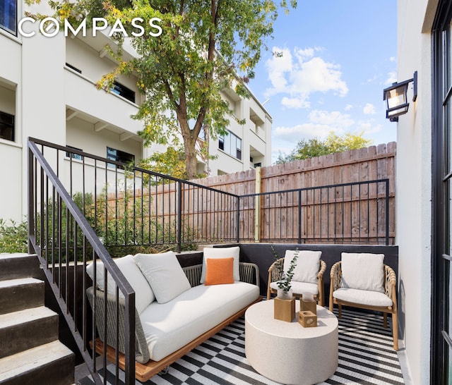 view of patio / terrace featuring an outdoor hangout area and fence