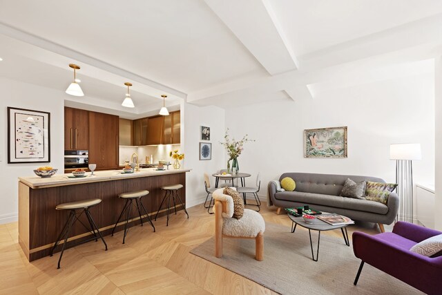 living room featuring beam ceiling and baseboards