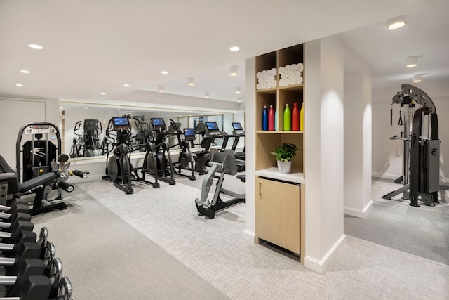 workout area featuring light carpet