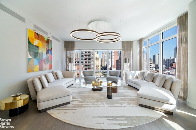 living room with hardwood / wood-style floors and an inviting chandelier