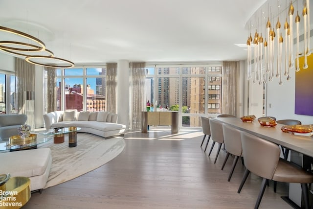 dining room with hardwood / wood-style flooring and a notable chandelier