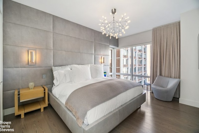 bedroom with an inviting chandelier, tile walls, and dark hardwood / wood-style floors