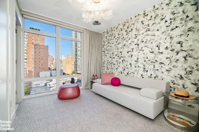 interior space with a chandelier, a healthy amount of sunlight, and carpet floors