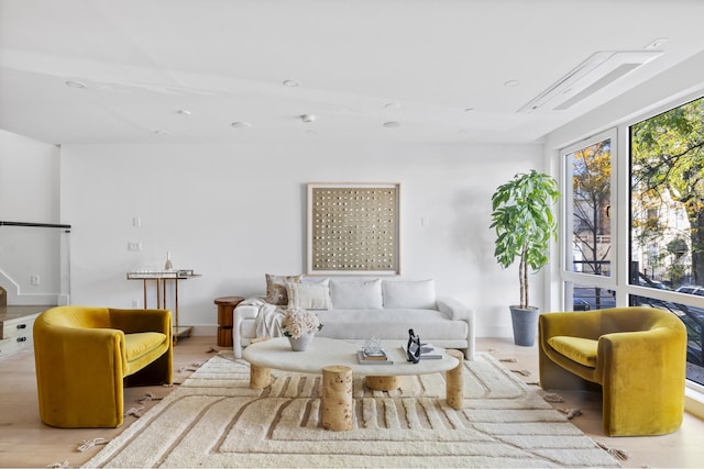 living area with baseboards and wood finished floors