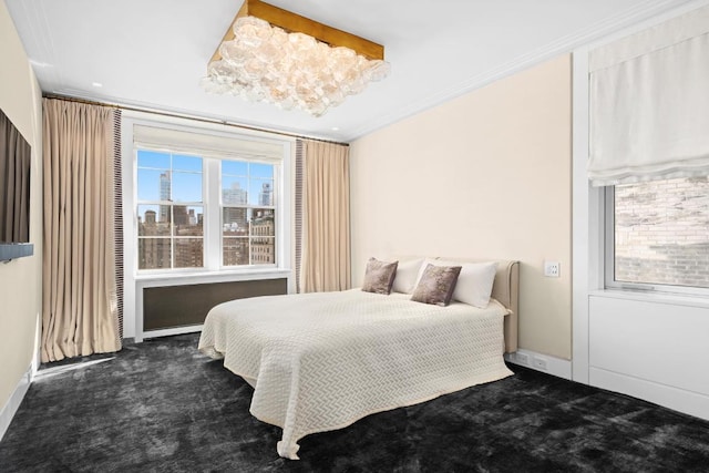 bedroom with dark colored carpet and ornamental molding