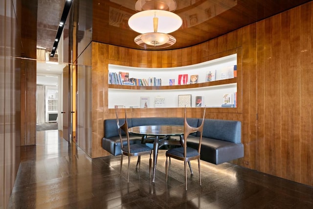 interior space with built in shelves and wooden walls